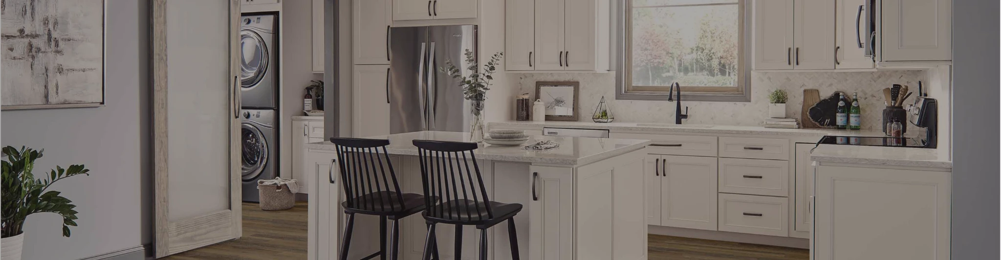 wood-look flooring in a kitchen with white cabinetry