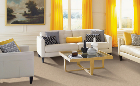 Beige carpet with white sofa in living room with yellow curtains